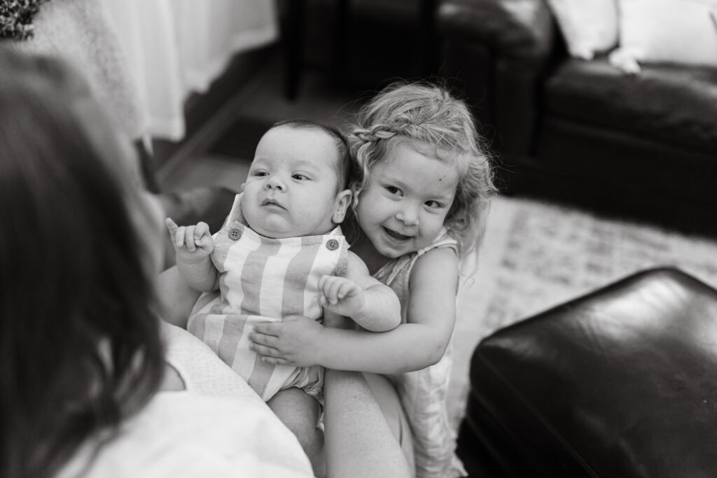 Chicago newborn session with siblings hugging.