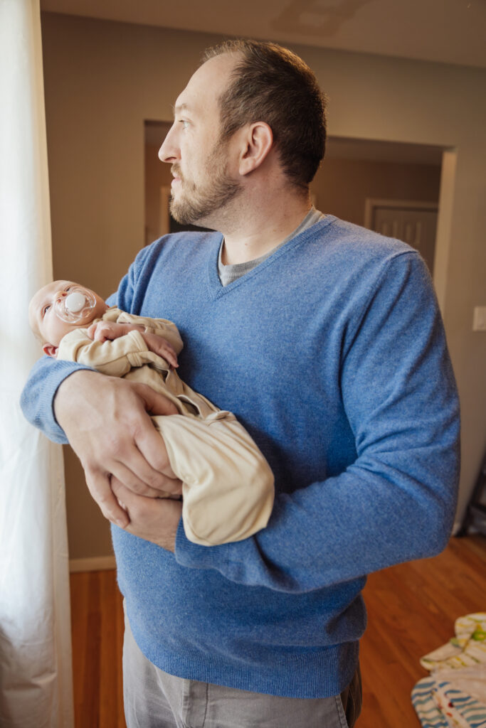 Dad and newborn son in-home newborn session in Chicago, IL by Taylor Lynn Studios