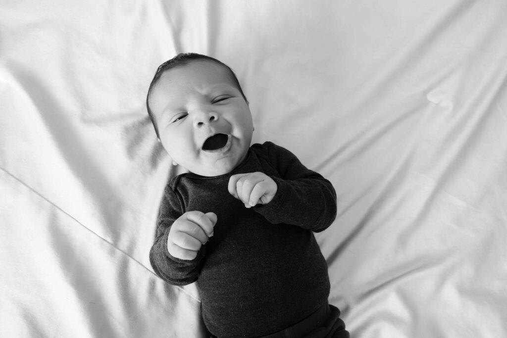 Yawning newborn in black and white in Elmhurst IL by Taylor Lynn Studios