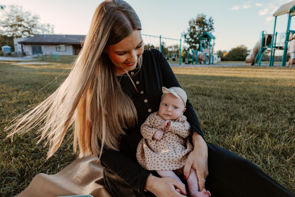 postpartum mother and baby enjoying a quiet moment in family friendly park in Chicago.