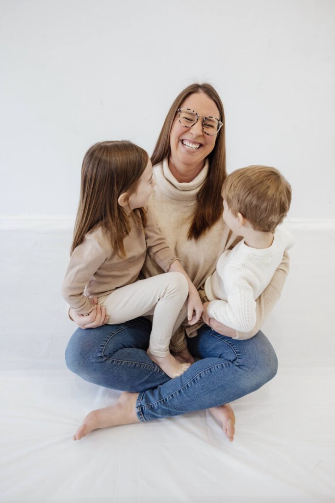 Mom and two kids in white studio in chicago il by Taylor Lynn Studios