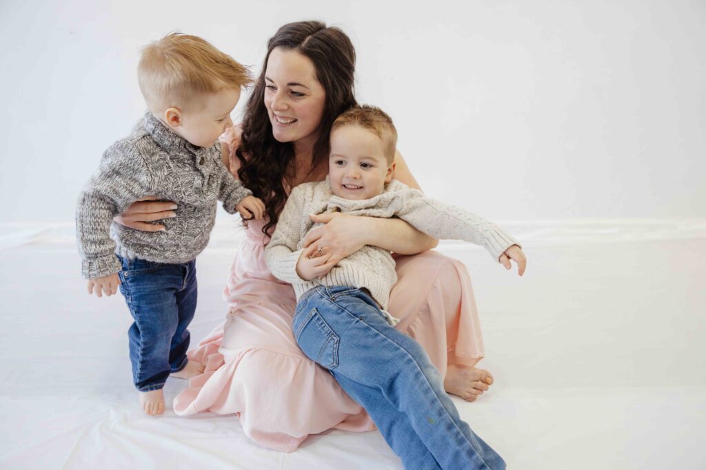 Mom and son cuddling in a white studio in wheaton il by Taylor Lynn Studios