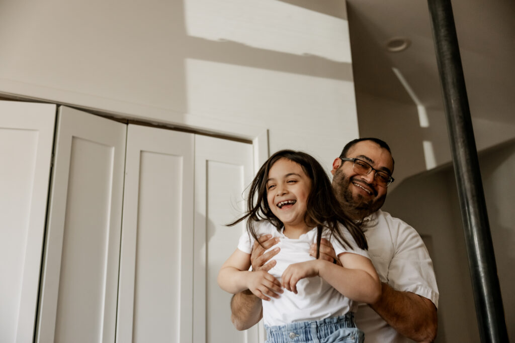 Dad playing with daughter during family session in chicago, il