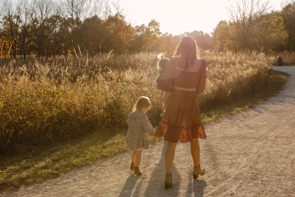 Mom and her daughters walking during fall photography session in Chicago, IL