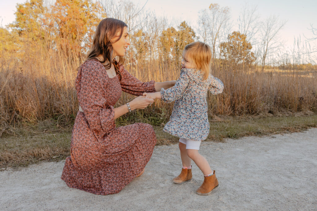 Mom dancing with daughter during Fall family photography session in Chicago, IL