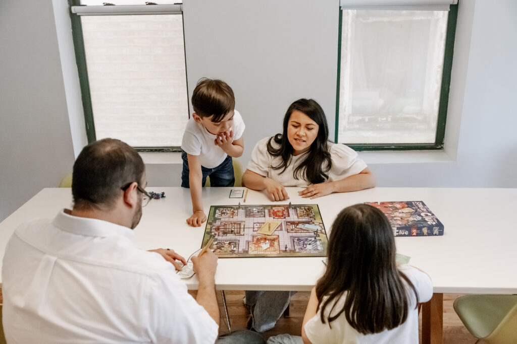 Family board game during documentary style photography session by Taylor Lynn Studios