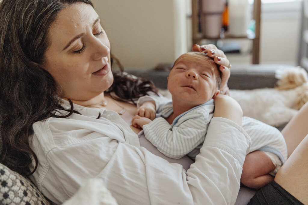 Mom holding scrunchy newborn during newborn session in chicago, il