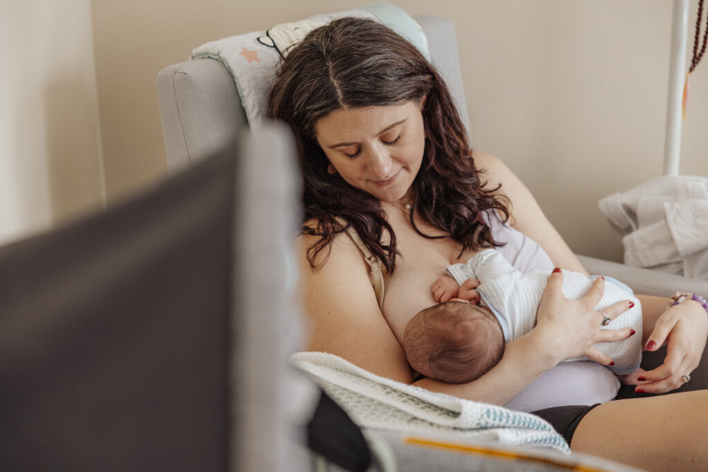 Mm breastfeeding baby during in home newborn session in chicago, il